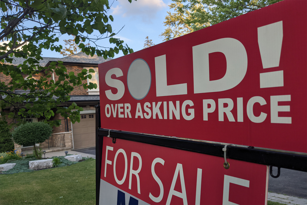 A for sale yard sign saying "Sold! Over Asking Price"